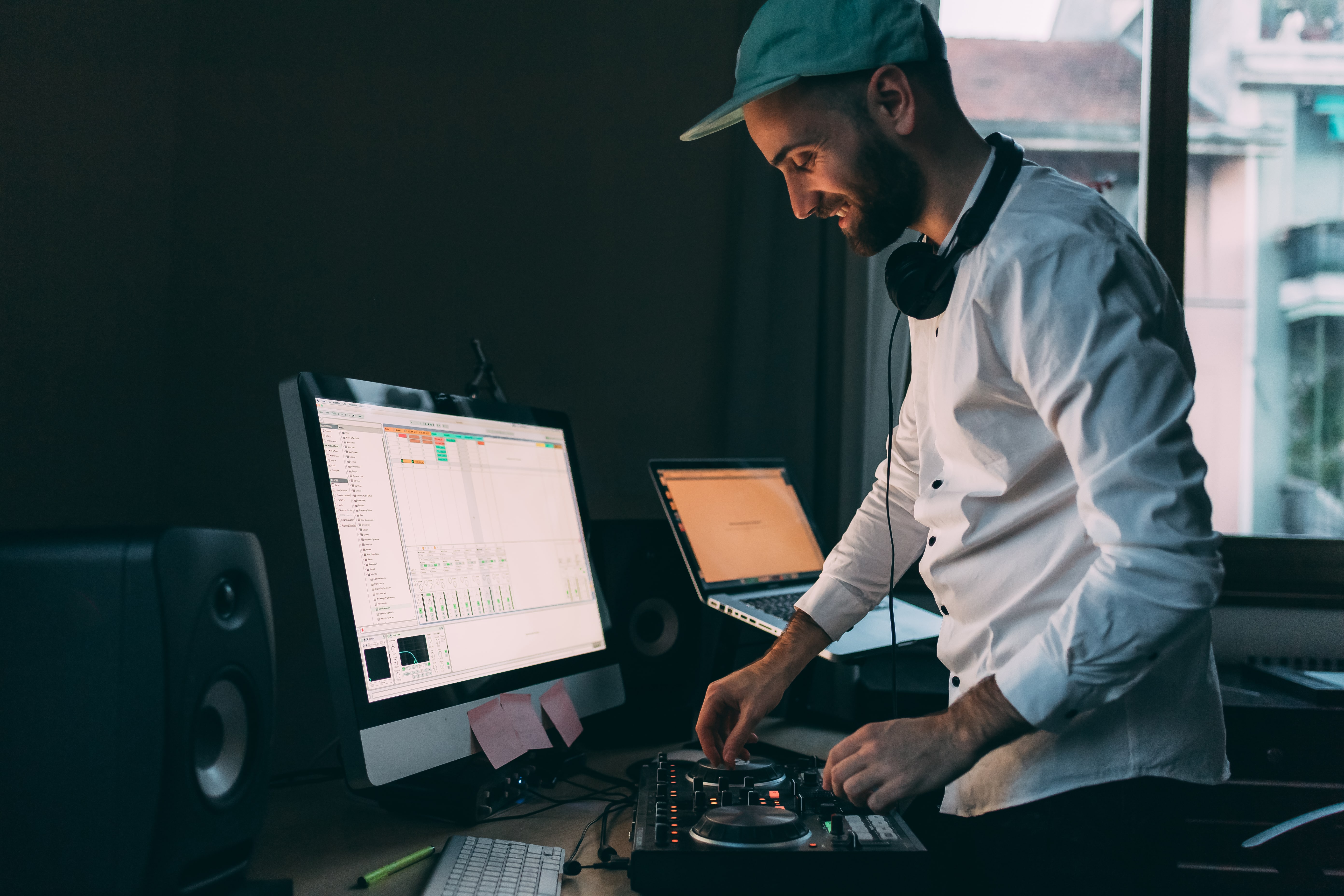 young dj indoor using mixing desk
